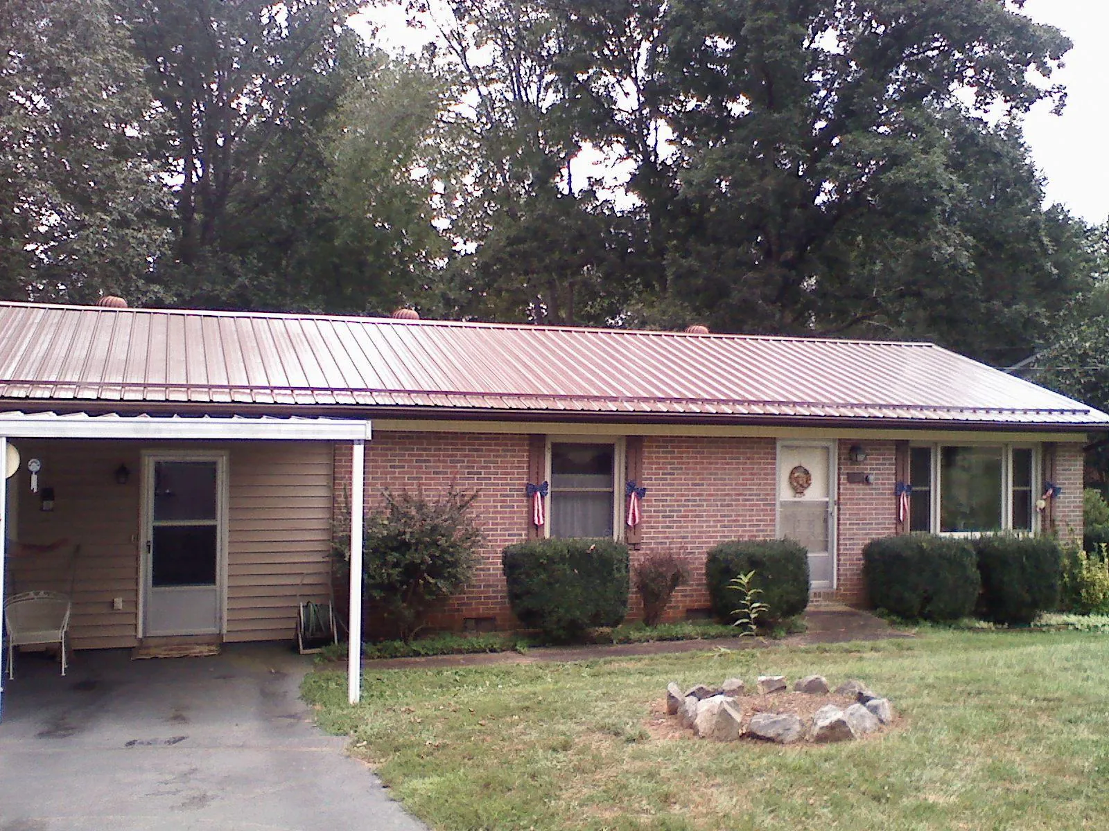 Bronze metal roof and carport on a brick ranch home — Roof Repair work by our crew in Trabuco Canyon